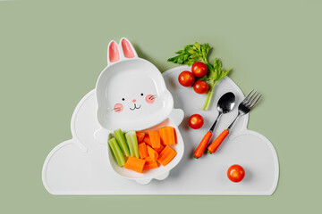 Cute plate in the shape of a bunny with  fresh vegetables. Food idea for kids. Children's healthy food with carrot