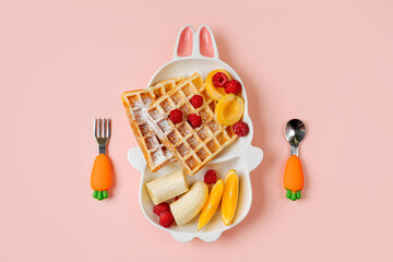 Children's Breakfast. Cute plate in the shape of a bunny with waffles and fruits. Food idea for...