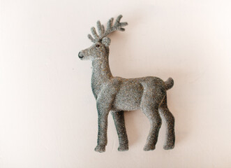 A minimalistic home decor element featuring a textured reindeer sculpture.