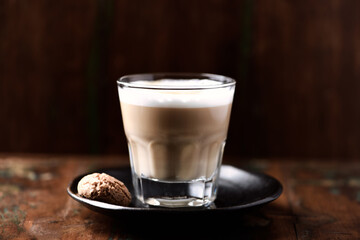 Coffee with milk on dark wooden background. Soft focus. Close up. Copy space.