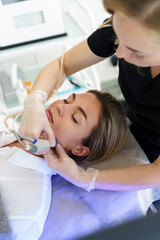 Woman during deep facial cleansing in a cosmetology clinic