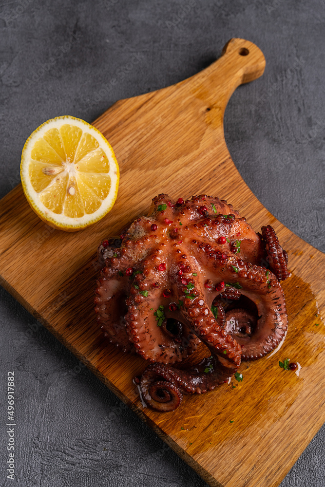 Sticker grilled octopus on wooden board