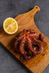 grilled octopus on wooden board
