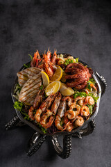 Mixed grilled seafood. Various roasted shrimps, mussels and shellfish in frying pan. Top view flat lay with copy space