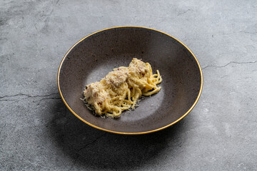 Plate with delicious pasta on grey background