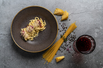 Plate with delicious pasta on grey background