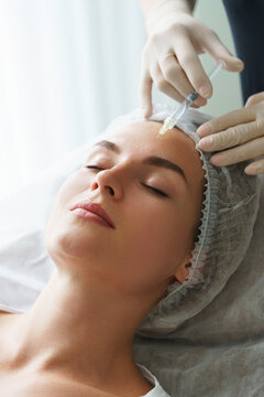 Woman during biorevitalization procedure in aesthetics medical clinic