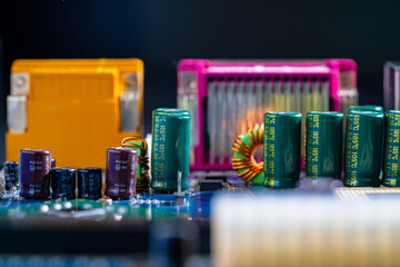 Motherboard with electronic components. Transistors capacitors resistors and other electronic components on motherboard. Chip and capacity on electronic board. Technological background. Close up.