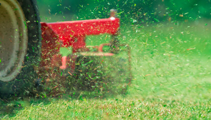 lawnmover at work in a meadow	
