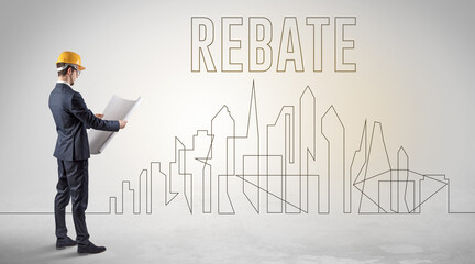 Businessman in hard hat holding blueprint