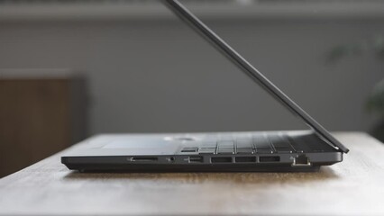 The unrecognizable man finished his work and closed his laptop.