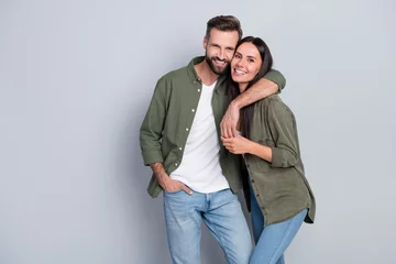 Foto op Canvas Portrait of attractive tender gentle cheerful couple life partners cuddling romance isolated over grey pastel color background © deagreez