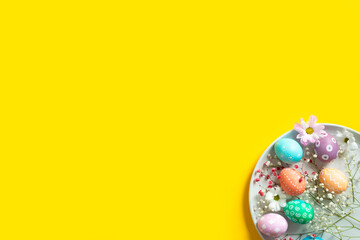 Beautiful Easter card with painted natural eggs and spring flowers on plate