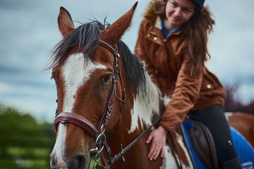 Trust is everything. Shot of a teenage girl riding her pony on a farm.
