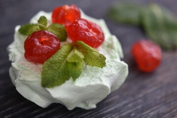 dried red cherry on a white marshmallow. sweet dessert