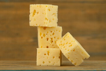 Stack cheese cubes on a wood kitchen table