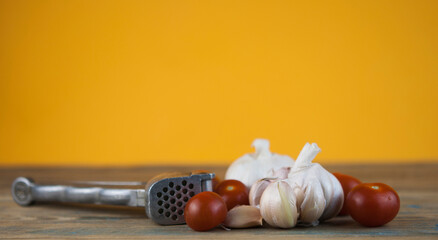 on wooden table cherry tomatoes with head garlic