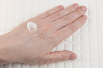 Women's hands applying cream. The concept of skin care.
