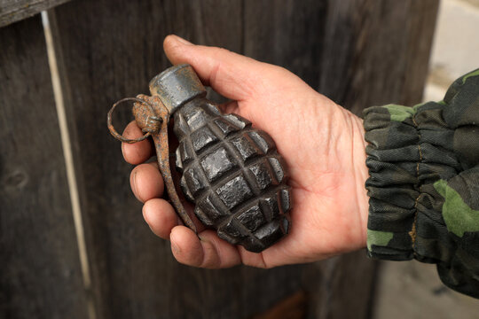 Old grenade of the first world war in a hand of a soldier