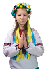 A little girl in national Ukrainian clothes with tearful eyes folded her hands in front of her and prays for an end to the war in Ukraine.