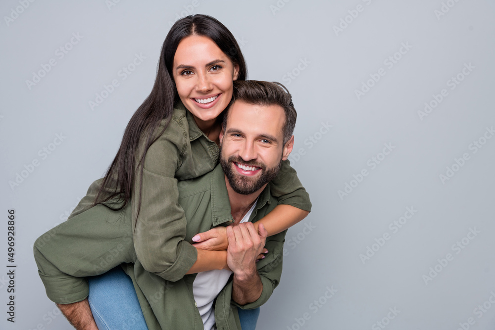 Poster portrait of attractive cheerful couple friends hugging having fun piggy backing weekend isolated ove