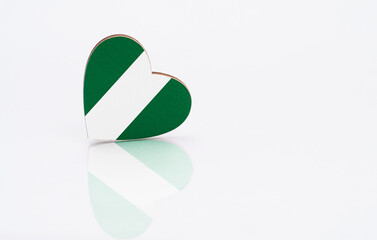 Flag of Nigeria in the shape of a heart on a white background. The concept of patriotism. copyspace.