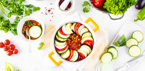 Preparation of ratatouille - a traditional French provincial vegetable dish. White background.