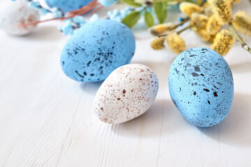 Willow branches and decorations, easter eggs on a light background. Happy easter concept with copy space