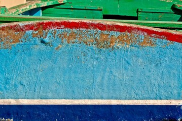 Detail of the hull of an old worn wooden fishing boat on the island Malta.
