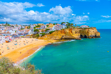 People are sunbathing on Praia de Carvoeiro beach in Portugal
