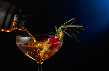 Cocktail with cherry, rosemary, and lemon.