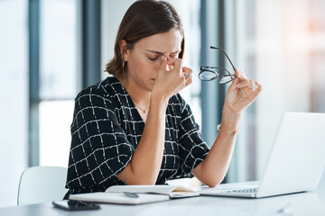Its a bad work day today. Cropped shot of a young businesswoman looking stressed while working in...