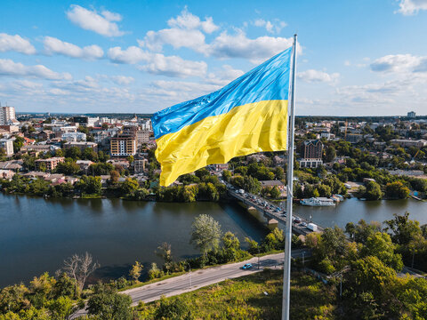 Ukraine flag on background of panoramic provincial country town Vinnitsa beautiful city with river