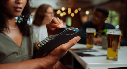 African american female tapping card on card machine