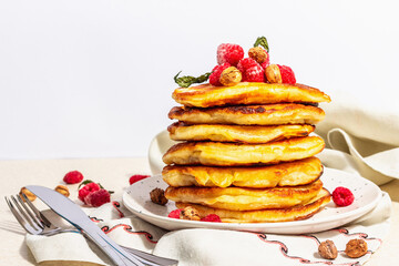 Classic homemade American pancakes with frozen raspberries, hazelnut and mint. Healthy breakfast