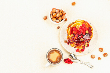Traditional homemade breakfast with pancakes and coffee. Raspberry, hazelnut, sweet jam