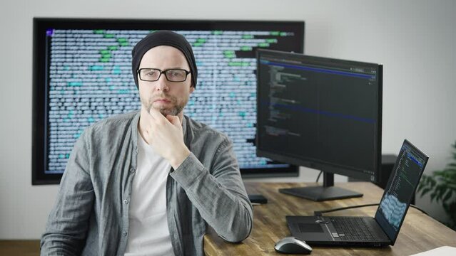 Portrait of a senior employee of the software development department. Serious man looks at the camera.