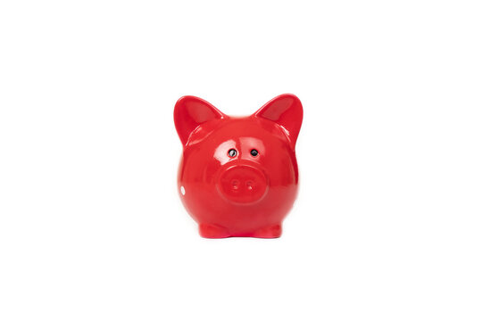 Photo of a red piggy bank for coins isolated on white background with copy space. Money and finance concept