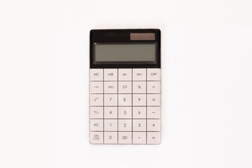 Obraz premium Photo of a white calculator isolated on a white background with copy space for text. Mathematics concept