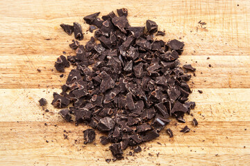 pieces of dark chocolate on wooden cutting board