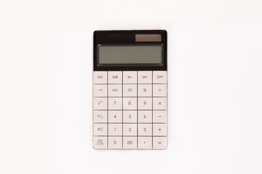 Photo of a white calculator isolated on a white background with copy space for text. Mathematics concept