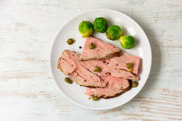 sliced roast beef on white ceramic plate
