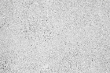 Plastered light gray wall surface background with scratches and cracks. High resolution grungy wall texture.