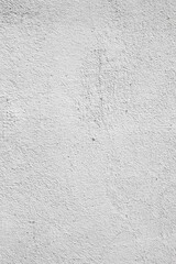 Plastered light gray wall surface background with scratches and cracks. High resolution grungy wall texture. Vertical orientation