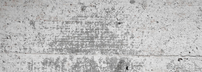 Light gray wall concrete surface background with scratches and cracks. High resolution grungy wall texture. Panoramic banner