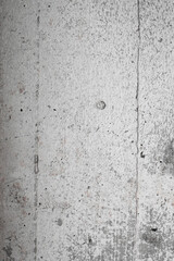 Light gray wall concrete surface background with scratches and cracks. High resolution grungy wall texture. Vertical orientation