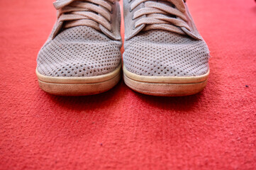 old style shoes, vintage style shoes on isolated red ground and carpet background.