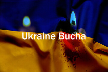 The flame of a candle against the background of the flag of Ukraine is yellow-blue, we mourn for...