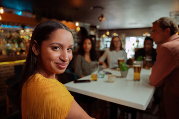 diverse women smiling while out for dinner with friends