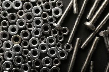 Metal nuts and bolts close up on black background